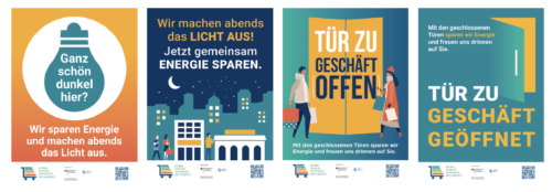 Drei Plakate, die darauf hinweisen, dass ein Geschäft Energie spart